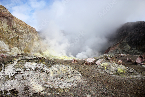 a smoking rocky volcano with steaming sulphur vents