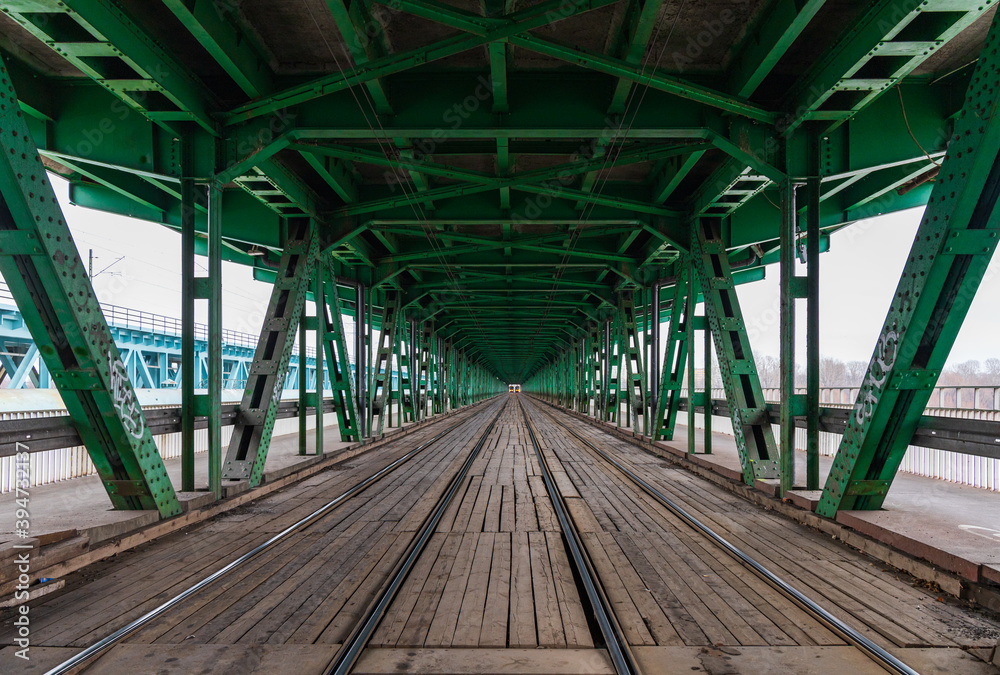 Long wooden and metal bridge with tram rails and green roof