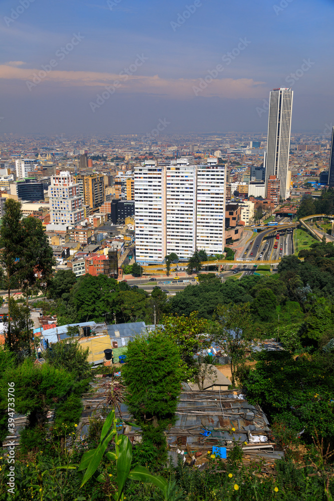Naklejka premium BOGOTA,COLOMBIA/MARCH 15,2018:Panoramic view of the city of Bogota. In the foreground are slum roofs.