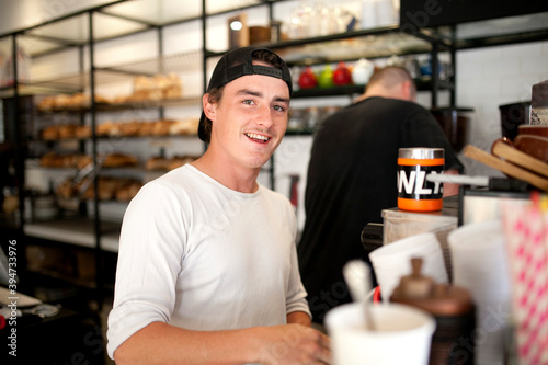 Smiling young man at work at cafe