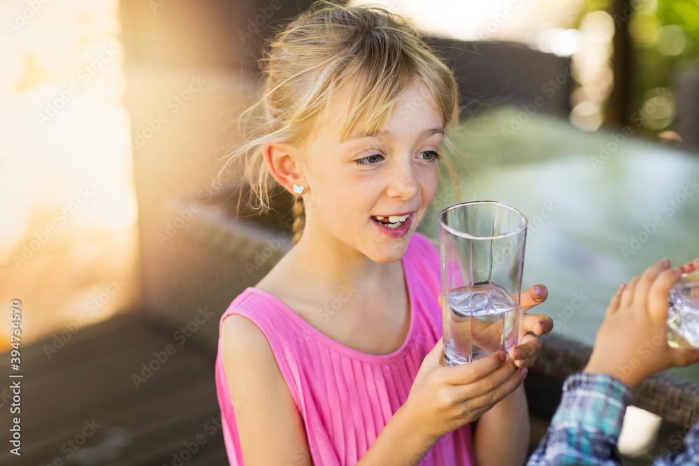 Children drinking water from a glass Children drinking water from a glass