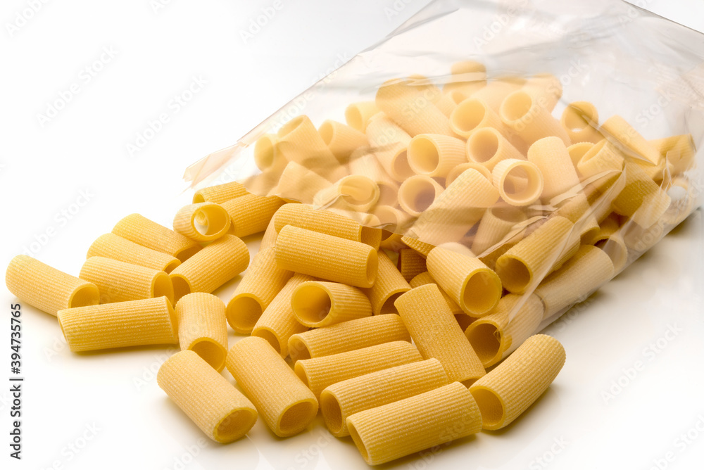 Paccheri macaroni Italian dry raw pasta bronze drawn, rough paste from Gragnano,Naples,Italy, in transparent packaging on white background Paccheri macaroni Italian dry raw pasta bronze drawn, rough paste from Gragnano,Naples,Italy, in transparent packaging on white background