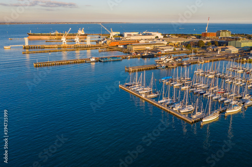 Aerial view of a bay side yacht club with rows of boats lined up along jetties photo