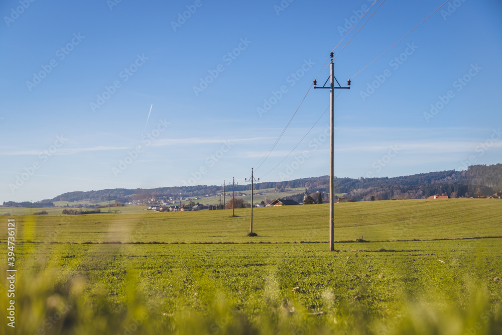 Green grass field with high voltage line in summer, nobody, wideness