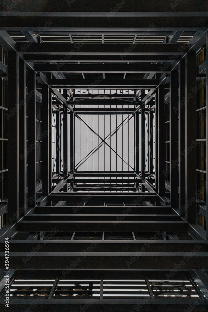 Fototapeta premium Upward view inside metal tower construction