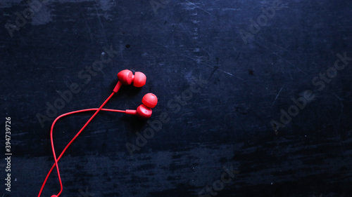 Red color ear phone in a dark background, Black friday concept