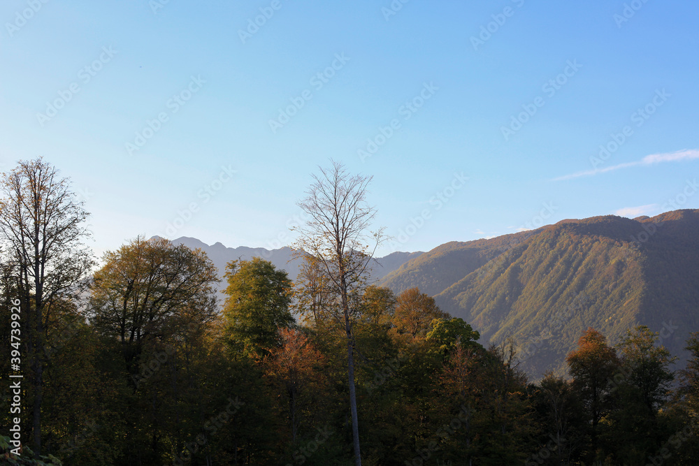 Fototapeta premium Beautiful bright panorama of the mountain landscape at sunset against the background of the blue sky