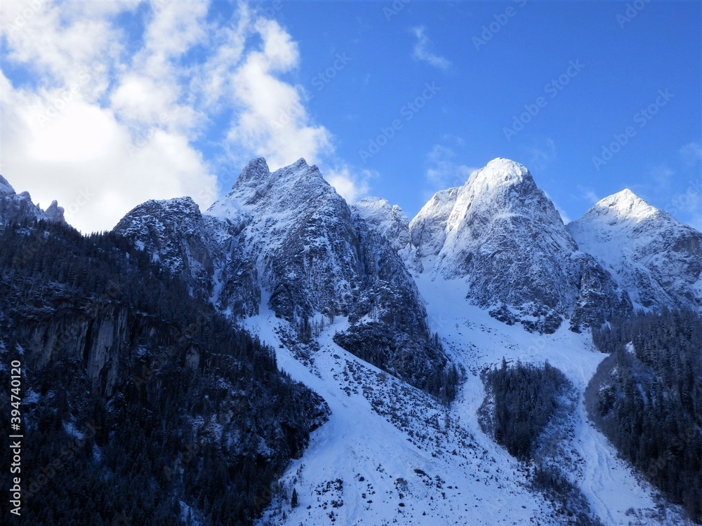 Snowy rocky mountains. Snowy mountain peaks. Amazing panorama of rocky mountains in winter.