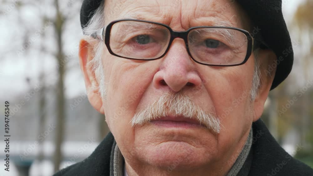 close up portrait of handsome american elderly man looking to camera intense focused