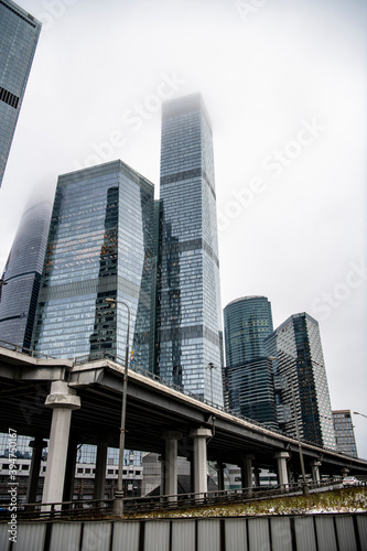 mesmerizing geometry of skyscrapers receding into the clouds against a gray sky