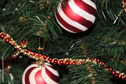Red and white Christmas toys hang on the Christmas tree . Backgrounds
