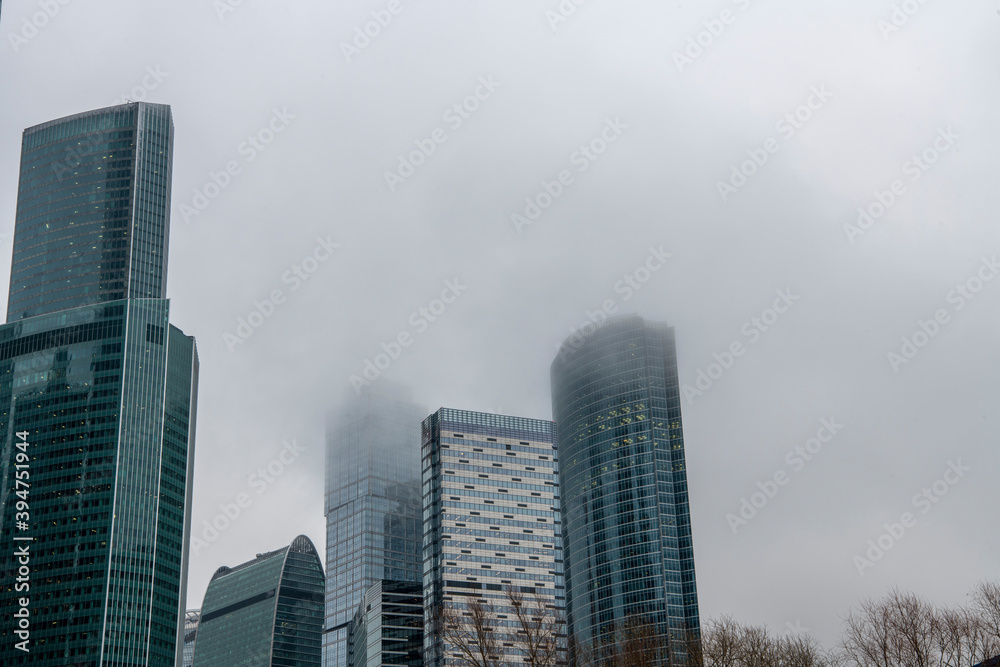 mesmerizing geometry of skyscrapers receding into the clouds against a gray sky