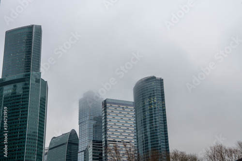 mesmerizing geometry of skyscrapers receding into the clouds against a gray sky