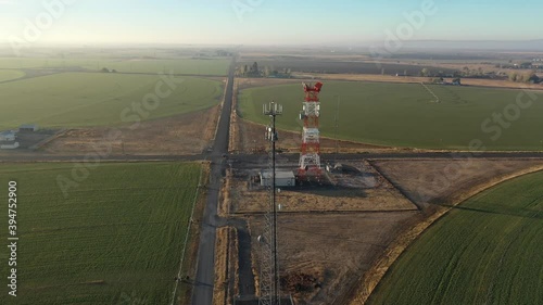 Communication towers stand on rural farmland to transmit cell and radio signals