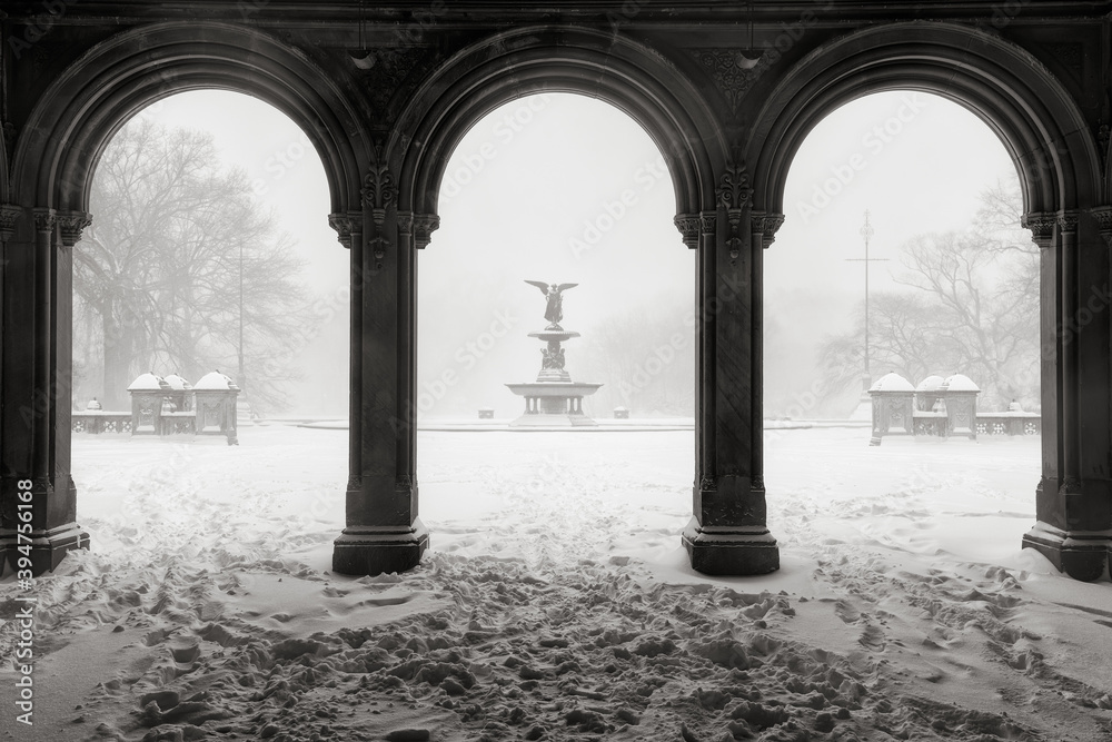 Black & White view of the Bethesda Fountain from the Bethesda Terrace Arcade during a winter snowstorm. Central Park, Manhattan, New York City