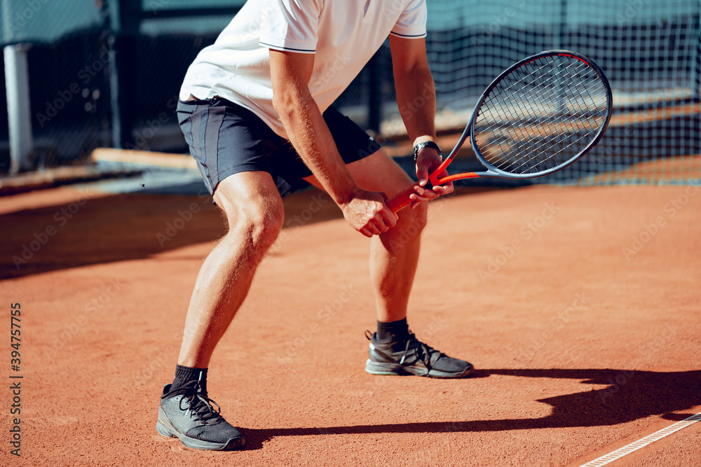 Tennis player standing in ready position on tennis court