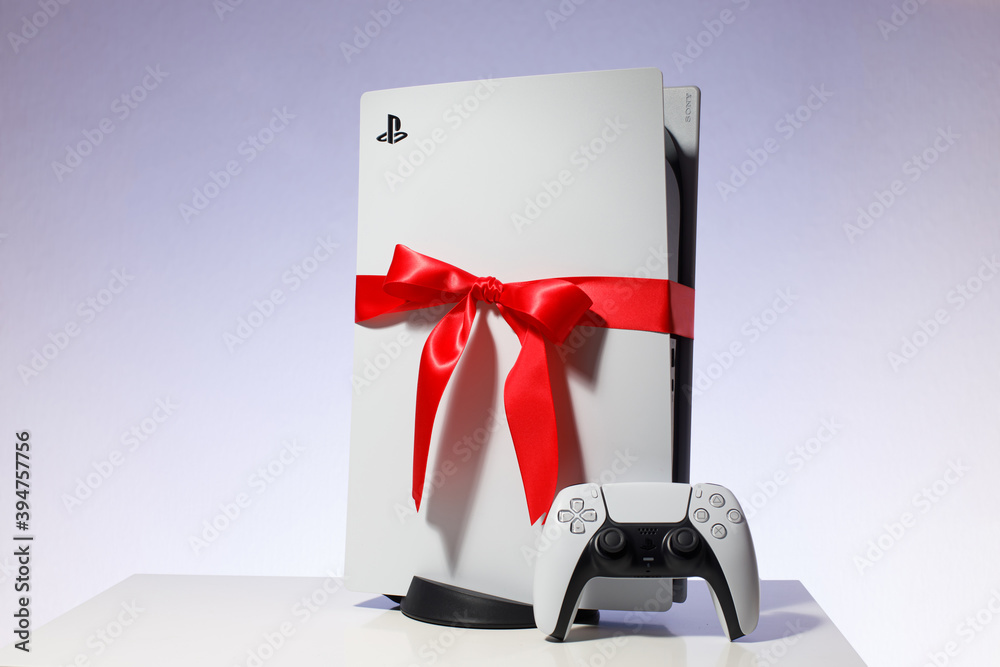 Sony PlayStation 5 game console on black background. Gift edition with red  ribbon black friday deal Stock Photo | Adobe Stock