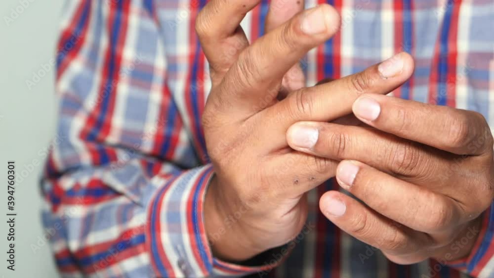 man suffering pain in finger close up 