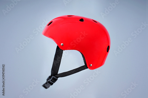 Children's red bicycle helmet on a plain background