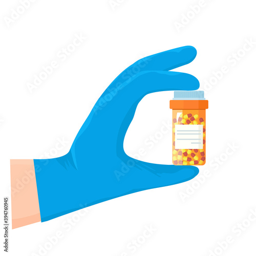 A doctor holding a medicine in a medical glove. concept of treatment and prevention of covid 19.