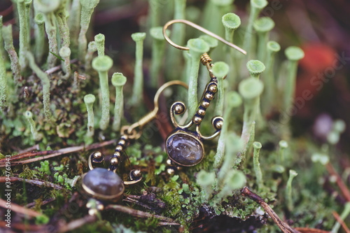 Brass metal earring with labradorite gemstone inside green moss mushrooms