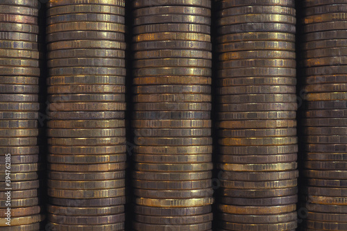 Background or wall from piles and edges of yellow brass coins close-up. 10 ten Russian rubles. Dark textured backdrop or wallpaper for economic, banking, financial, monetary topics. Macro