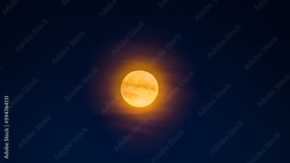 Big moon in dark night sky. natural satellite of the earth in light clouds. Big moon in dark night sky. natural satellite of the earth in light clouds.