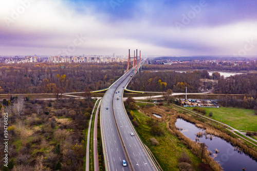 Aerial drone view. bridge in the rays of a sunny morning. Autumn haze in the air, cars are driving across the bridge.