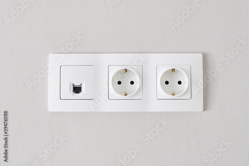 electrical and ethernet white socket on the wall.