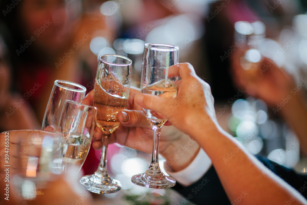 Closeup of wedding guests toasting champagne
