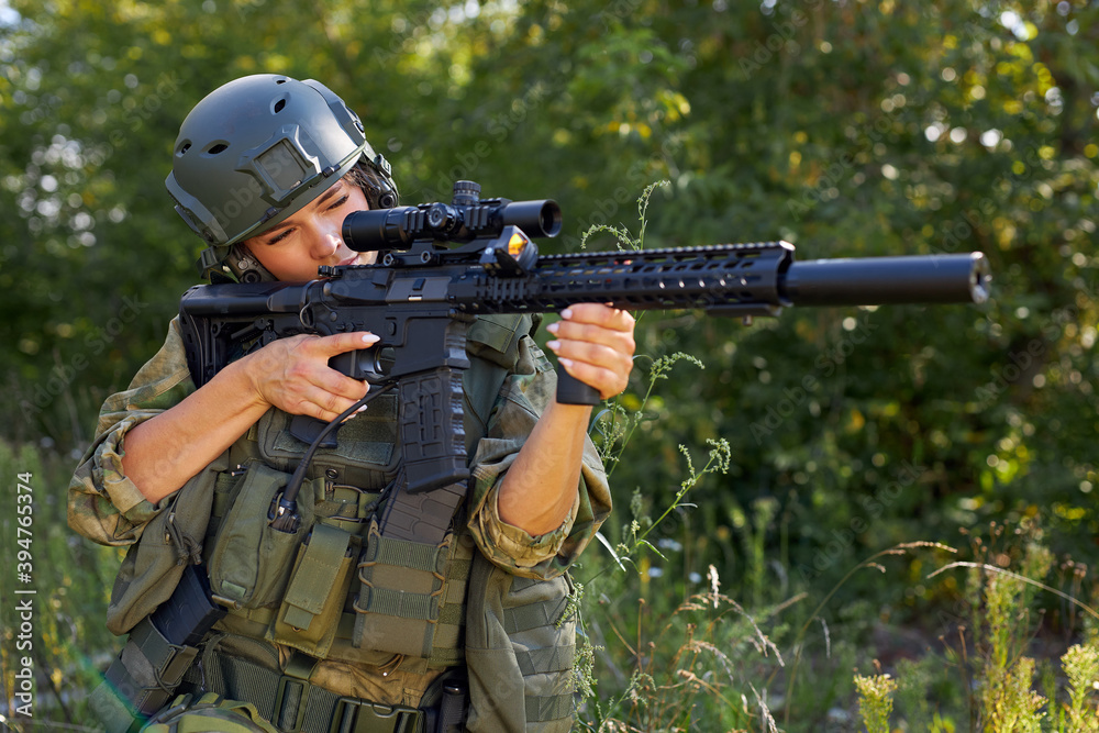 sportive caucasian woman soldier shooting with rifle machine gun in the forest, young slim female is hunting sportive caucasian woman soldier shooting with rifle machine gun in the forest, young slim female is hunting