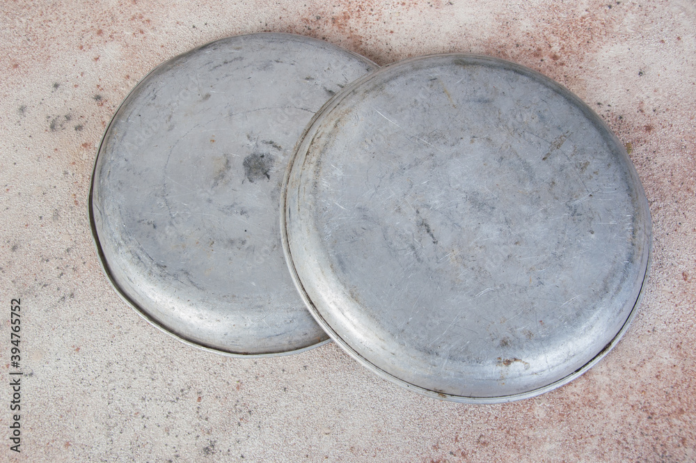 Old metal plates for scales on concrete background. Old metal plates for scales on concrete background.