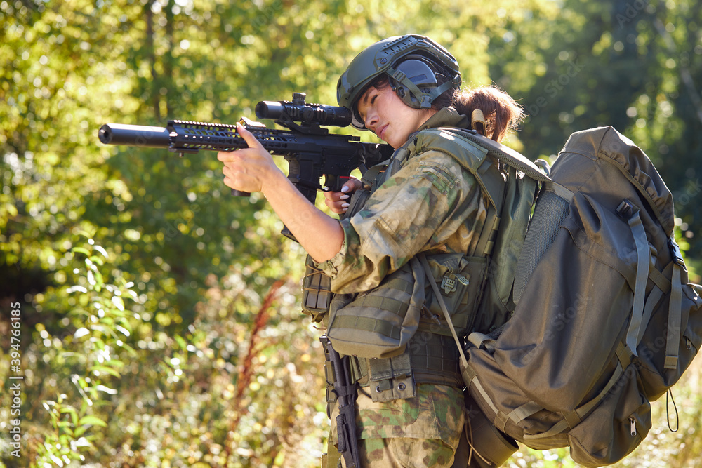 Fototapeta premium military woman has hobby activity, practice lends success hunting, female has hunting experience in nature environment. hunting weapon gun or rifle, hunting target concept