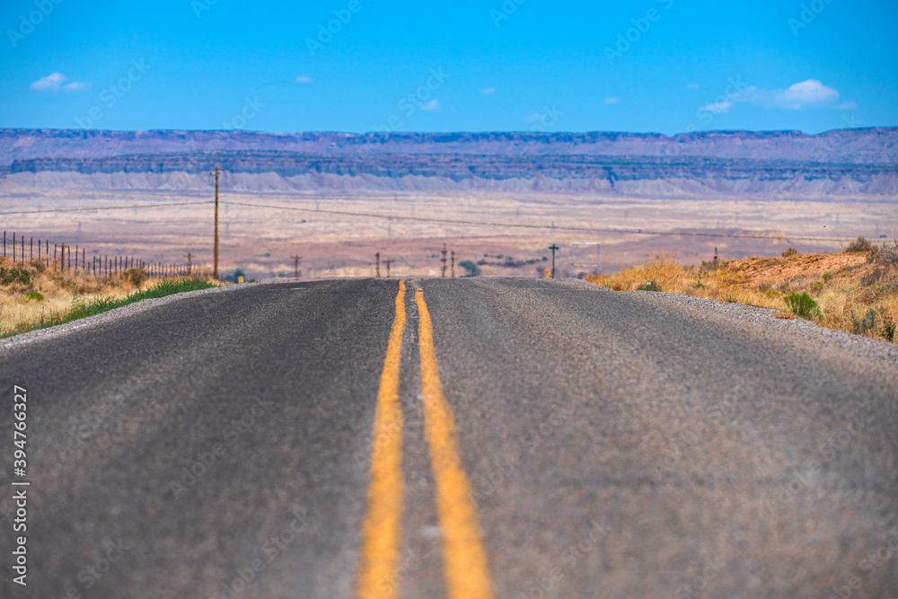 Roud of Mojave Desert near Route 66 in California. Scenery with highway. Asphalt highway and hill landscape under the blue sky. Roud of Mojave Desert near Route 66 in California. Scenery with highway. Asphalt highway and hill landscape under the blue sky.
