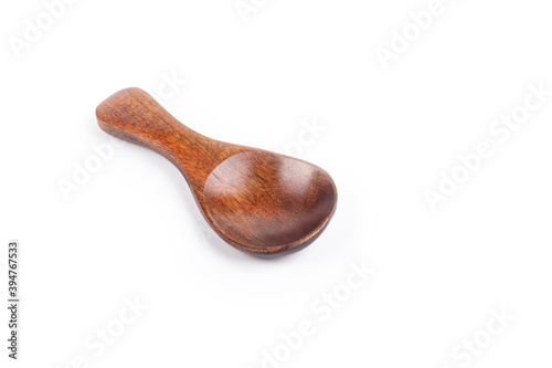 Studio lighting. small spoon from a beautiful wood for spices on a white background. No isolation. Close-up.