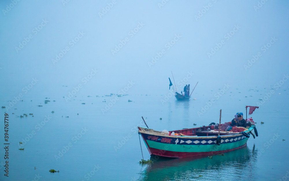 Fototapeta premium Fisherman fishing in the winter morning,
