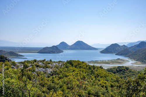 Beautiful view Skadar (Skoder) lake among the mountains. This section of the lake overgrown with tall grass. Montenegro.