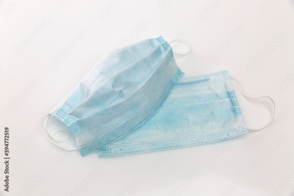 Medical masks on a light gray background. Top view. Coronavirus pandemic. Medical masks on a light gray background. Top view. Coronavirus pandemic.