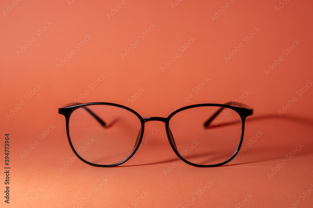 glasses on a orange table background