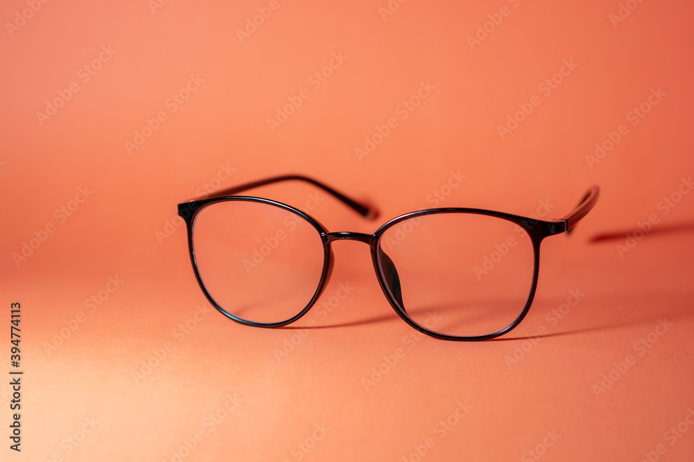 glasses on a orange table background glasses on a orange table background