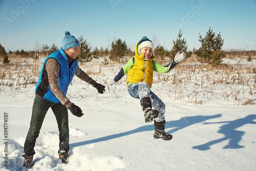 playing father and son in the winter outdoors
