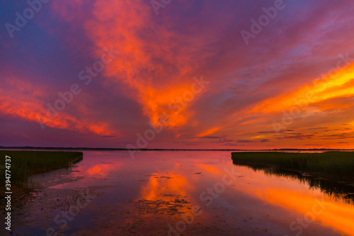 Beautiful colorful sunset over the lake summer landscape.