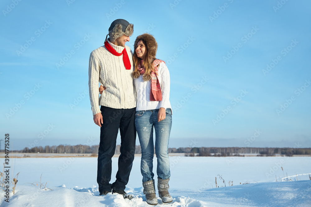 Young couple in love in the winter outdoors
