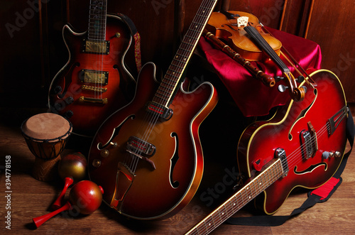 Canvas Print Three jazz electric guitars, violin, maracas, djembe in the interior