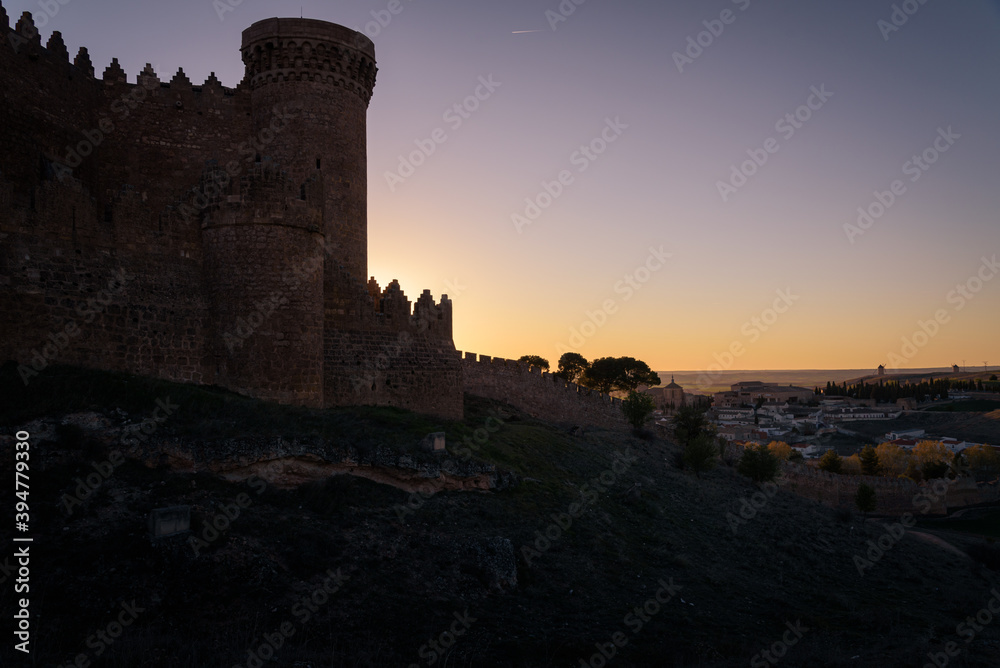 Exterior view of the medieval castle and the village of Belmonte at sunset, Cuenca, Spain