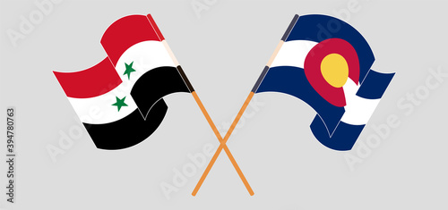 Crossed and waving flags of Syria and The State of Colorado
