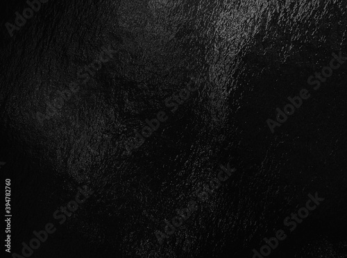 Black foil background with highlights and uneven texture