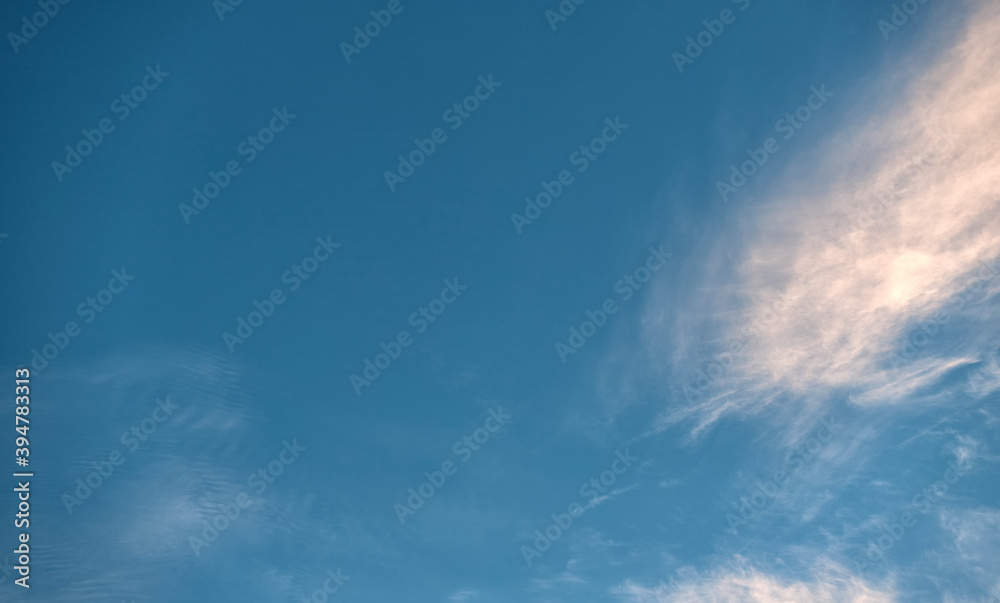 Beautiful evening blue sky, with white cirrus clouds of different shapes