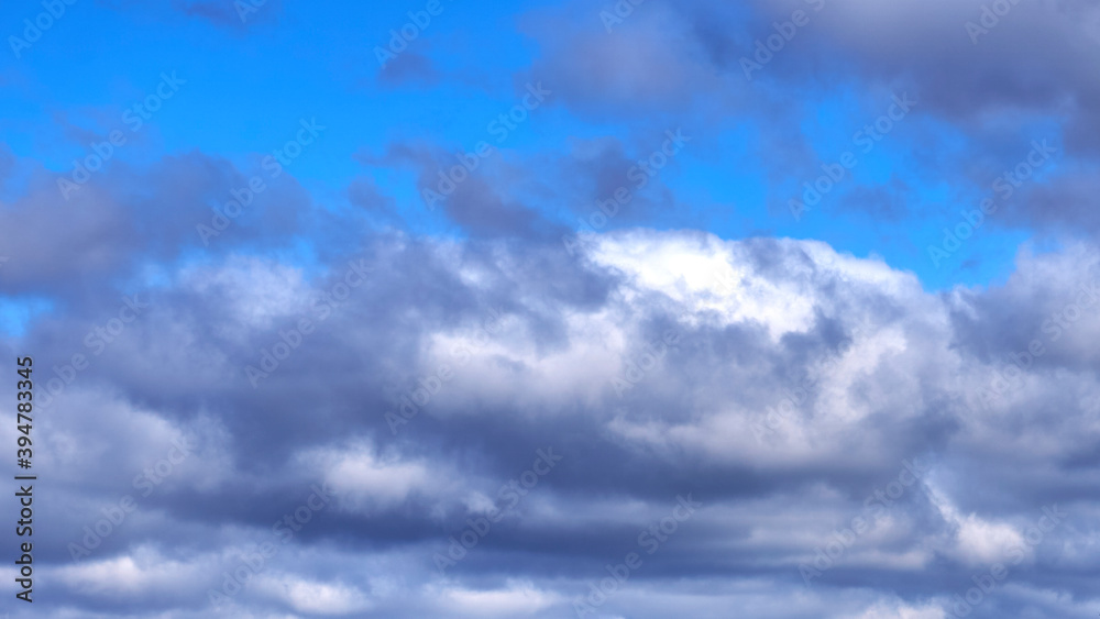 Dark clouds against a blue sky