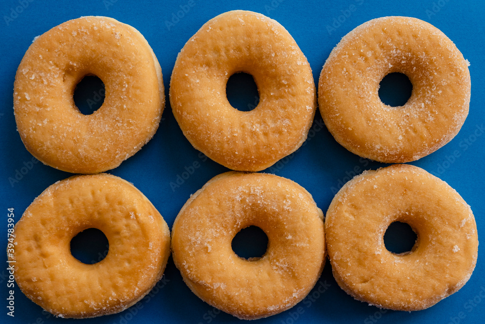 six doughnuts on blue background